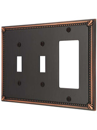 Imperial Bead Double Toggle/GFI Combination Switch Plate in Aged Bronze.